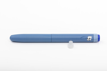 Blue Insulin Pen with Used Needle on White Background for Diabetes Treatment, Do not reuse needles!