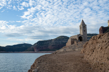 Sau reservoir very dry with little water and bell tower of San roman de Sau in Girona Catalonia Spain