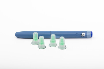 Blue Insulin Pen with New Needles for Type 1, Type 2 Diabetes Treatment on White Background