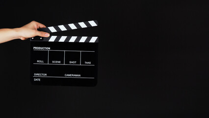 Fototapeta na wymiar Hand's holding Clapperboard or movie slate on black background.