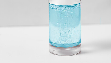 Hyaluronic acid in glass bottle on white background with clipping path close-up, Liquid blue gel or serum bubbles, Medicine and Pharmacology. Beauty skin care concept Beauty and spa.