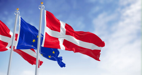 The flags of Denmark and the European Union waving together on a clear day - obrazy, fototapety, plakaty