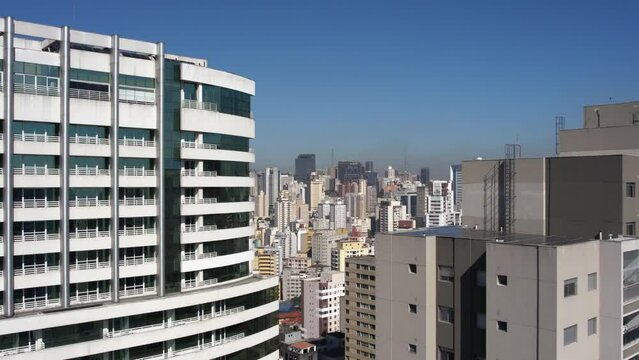 Aerial view rising over apartments, revealing the cityscape of Bela Vista, Sao Paulo, Brazil