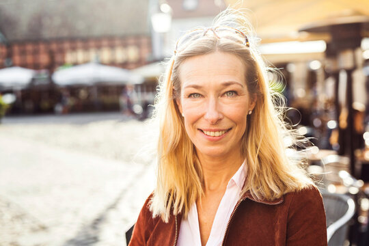Portrait of blonde woman in city