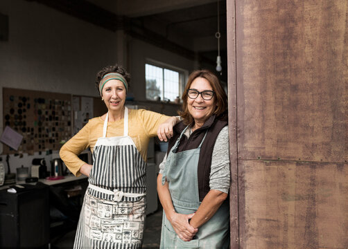 Portrait of two female potters in workshop