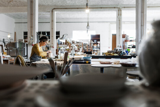 Woman working in pottery workshop