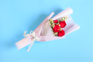 Bouquet of Red rose flowers with white flowers decorated on blue background, Bouquet flowers for Valentines and special days
