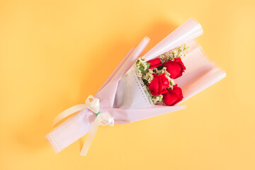 Bouquet of Red rose flowers with white flowers decorated on yellow background, Bouquet flowers for Valentines and special days