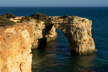 Fototapeta na wymiar Landscape of Albandeira beach, cliffs, and natural arch in the Algave region at sunset. Portugal.