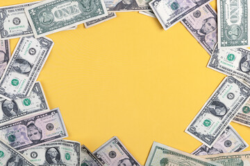 cash scattered on colorful background with negative space