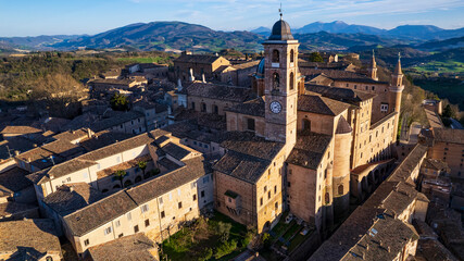 Obraz premium One of the most beautiful medieval towns of Italy - Urbino in Marche region. aerial drone panoramic high angle view over sunset