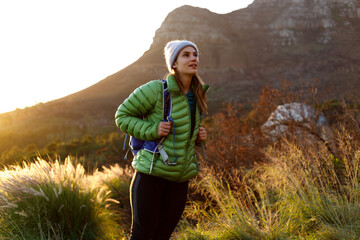 Portrait of smiling female caucasian hiker in winter clothes
