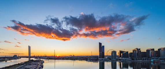 Silhouettes of city buildings in Melbourne's docklands at sunset