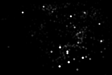 White gray blurred bokeh lights on black background. Glitter sparkle stars for celebrate. Overlay for your design