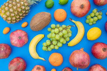 Fresh tasty healthy exotic fruits on blue background