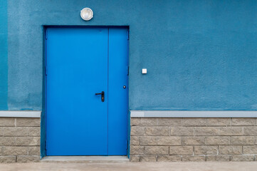 blue metal entrance door and part of the wall