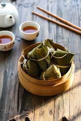kue cang or zongzi is sticky rice wrapped in bamboo leaves
