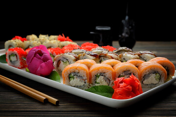 Exquisite sushi rolls with traditional accompaniments, with wasabi and ginger