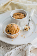 Peanutbutter and chocolate chips muffins homemade on white background close up selective focus