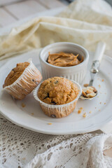 Peanutbutter and chocolate chips muffins homemade on white background close up selective focus