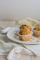Peanutbutter and chocolate chips muffins homemade on white background close up selective focus