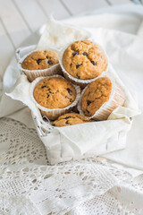 Peanutbutter and chocolate chips muffins homemade on white background close up selective focus