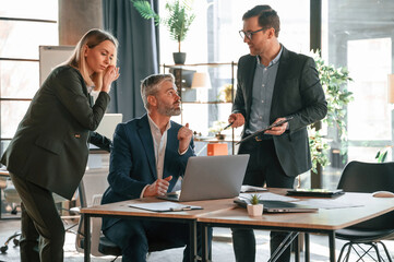 Men and woman indoors. Group of business people are working in the modern office