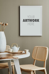 Cozy and stylish interior of kitchen space with wooden table with white mock up photo frame, design cups and rattan chairs. Scandinavian room decor with kitchen accessories and decoration. Home decor