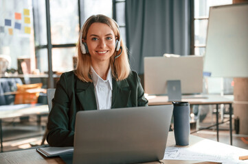 Young beautiful woman in formal clothes is working in the office