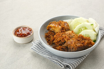 Ayam Goreng Lengkuas, fried chicken cooked with spices and sprinkled with grated galangal. Indonesian traditional food.  
