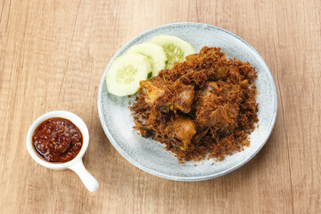 Ayam Goreng Lengkuas, fried chicken cooked with spices and sprinkled with grated galangal. Indonesian traditional food.  

