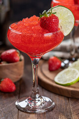 Frozen strawberry daiquiri cocktail with strawberries and lime