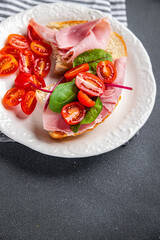 sandwich ham, tomato, lettuce bruschetta snack ready to eat healthy meal food snack on the table copy space food background rustic top view