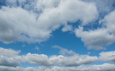 Naklejka na ściany i meble Summer white clouds on blue sky.