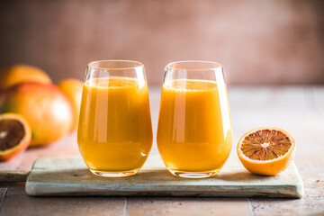 Two mango lassi or kesar milk in glasses. Indian healthy ayurvedic cold drink with mango. Freshness lassi made of yogurt, water, spices, fruits and ice.