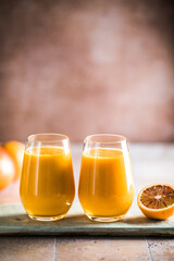 Two mango lassi or kesar milk in glasses. Indian healthy ayurvedic cold drink with mango. Freshness lassi made of yogurt, water, spices, fruits and ice.
