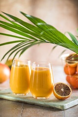 Two mango lassi or kesar milk in glasses. Indian healthy ayurvedic cold drink with mango. Freshness lassi made of yogurt, water, spices, fruits and ice.