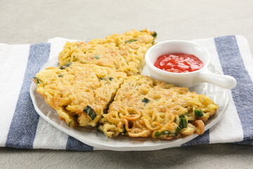 Martabak Mie, made from noodles mixed with eggs, leeks then fried. Indonesian food

