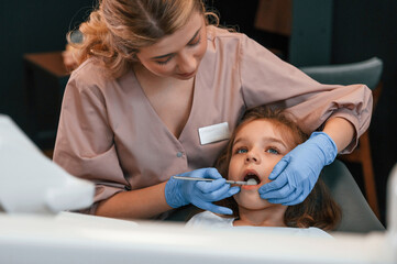 Obraz premium Woman is working with little girl teeth. In the stomatological cabinet