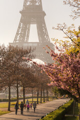 Eiffel Tower with people walking in spring park in Paris, France