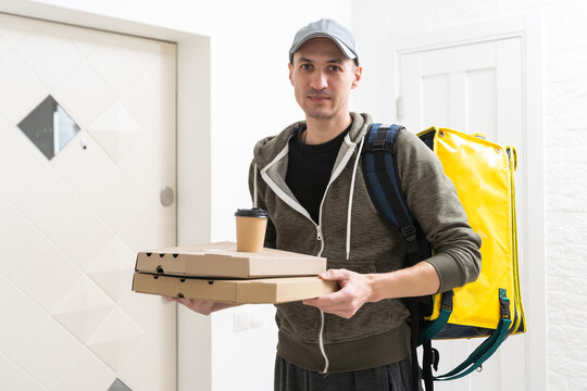 Full Length Portrait Of Smiling Delivery Man With Package And Clipboard On White Background.