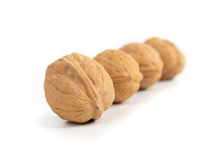 Walnuts in a raw. Close-up picture of dried fruits isolated on white backgroud.