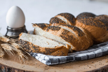 Classic wheat braid with poppy seeds. Delicious bread close-up. Freshly baked sourdough bread with...