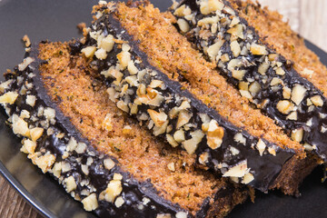 Pastry made of zucchini with nuts and raisin on plate. Delicious dessert