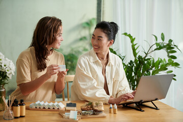 Businesswomen discussing orders they received via online shop