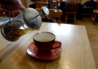 French press drink being poured into a cup
