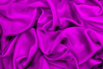 Obraz premium Satin beautiful silk fabric in lilac color lies with drapery. 