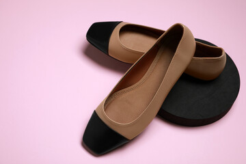 Pair of new stylish square toe ballet flats on pale pink background. Space for text