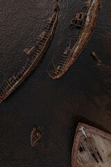 Cemetery of abandoned dead ships in Teriberka, Murmansk Oblast, Russia. The girl is lying on the bow of the ship