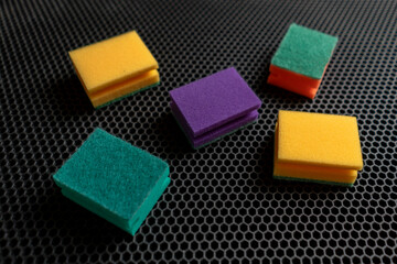 five cleaning sponges of different color flat lay, household concept